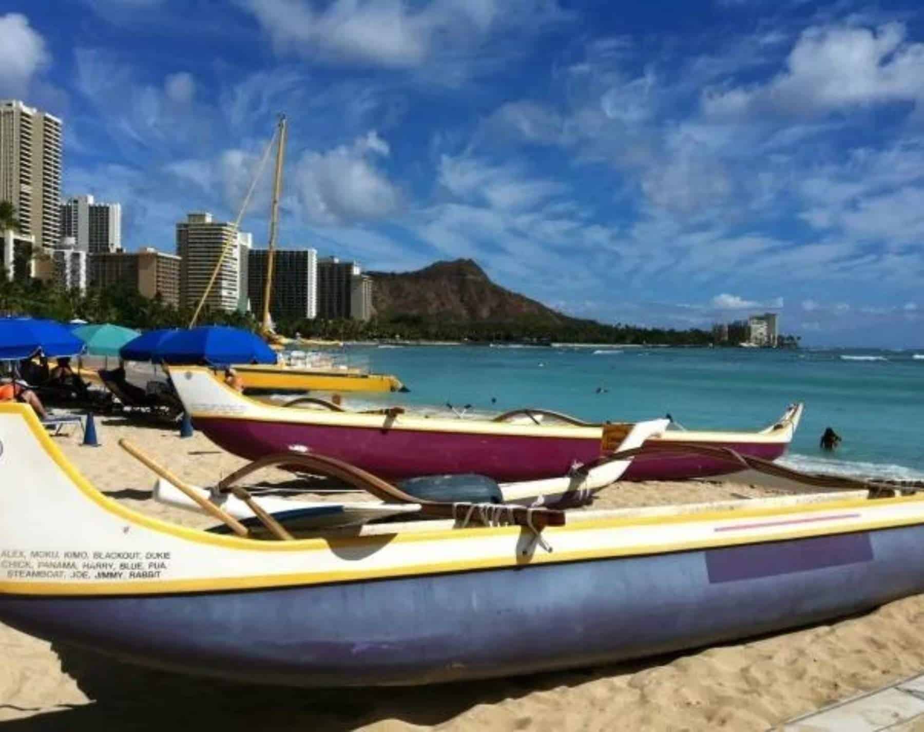 traditional outtrigger canoe sailing in oahu, hawaii.