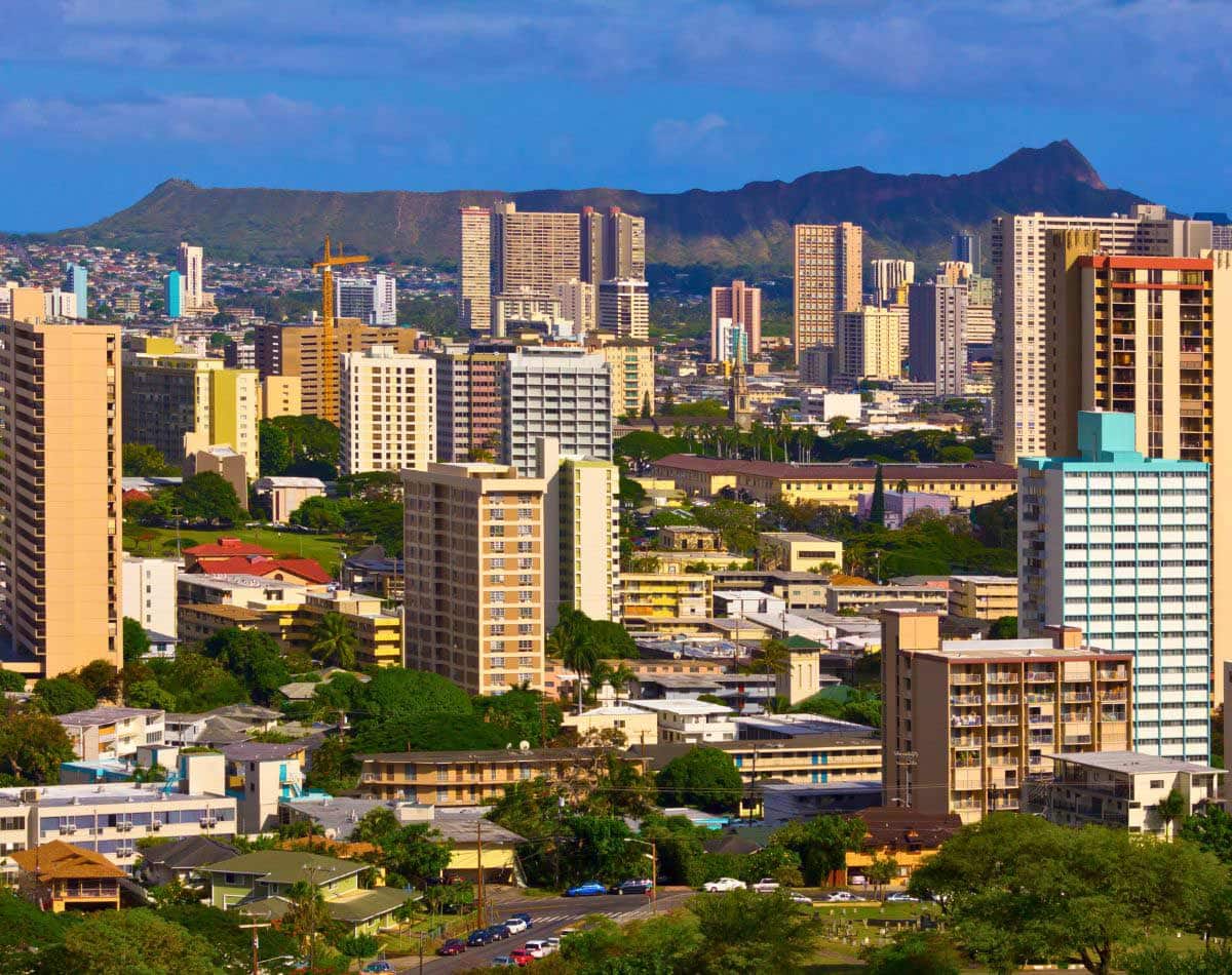 Honolulu Hawaii cityscape with a backdrop of Diamond Head Crater Hiking Trail.